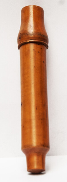 A 19th century glass syringe in its original boxwood container.