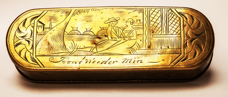 A brass 17th C. Dutch tobacco box with a naughty text.