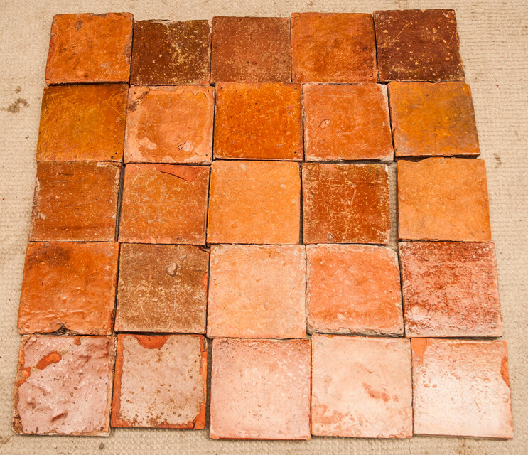 A collection of 25 glazed early seventeenth century ceramic floor tiles.