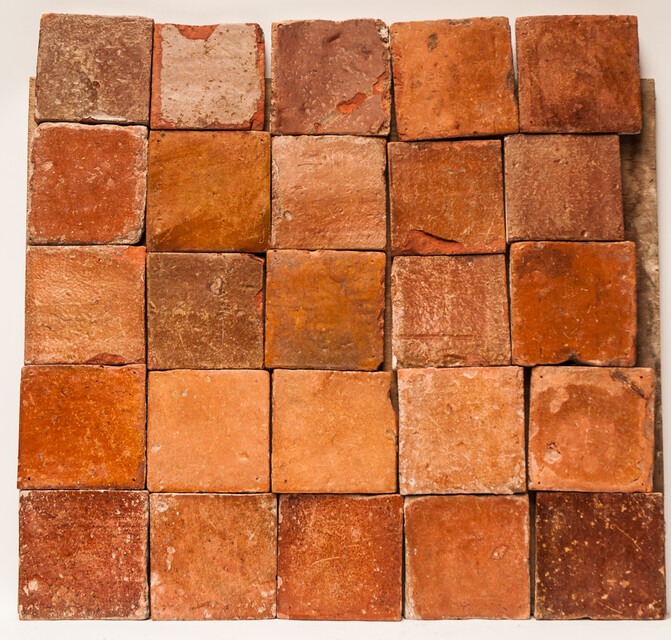 A collection of 25 glazed early seventeenth century ceramic floor tiles.