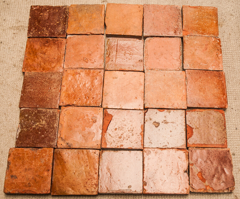 A collection of 25 glazed early seventeenth century ceramic floor tiles.