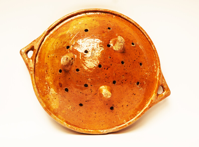 A large eighteenth century earthenware strainer made in Bergen Op Zoom.