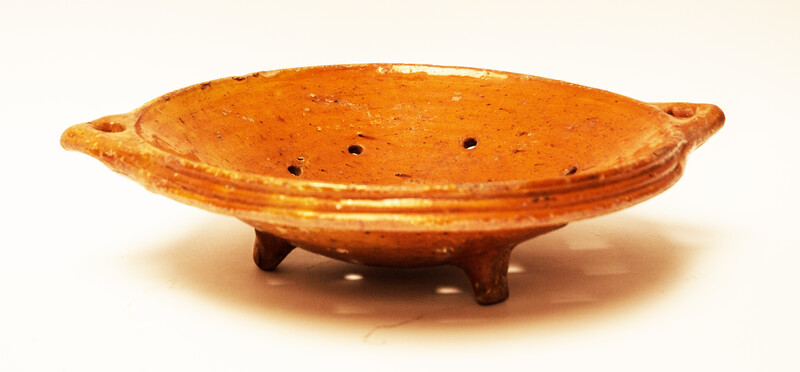 A large eighteenth century earthenware strainer made in Bergen Op Zoom.