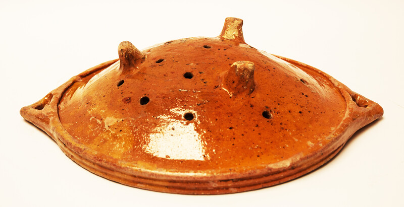 A large eighteenth century earthenware strainer made in Bergen Op Zoom.