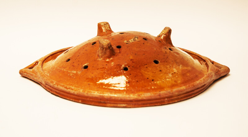 A large eighteenth century earthenware strainer made in Bergen Op Zoom.