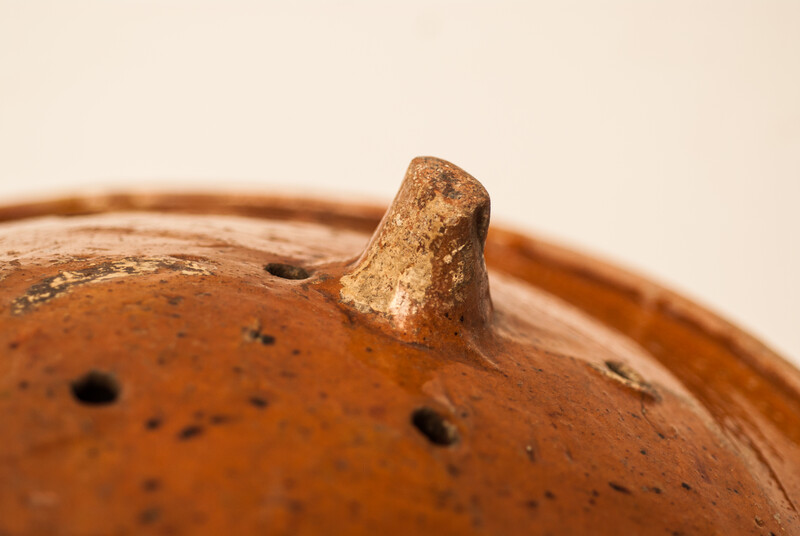 A large eighteenth century earthenware strainer made in Bergen Op Zoom.