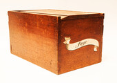 A large nineteenth century oak lidded box with a painted sign 