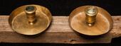 A pair of early seventeenth century brass church bench candle sticks.