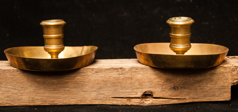 A pair of early seventeenth century brass church bench candle sticks.