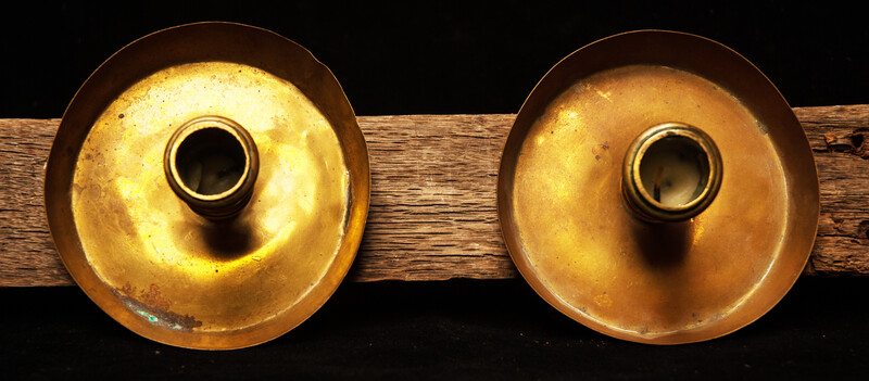 A pair of early seventeenth century brass church bench candle sticks.