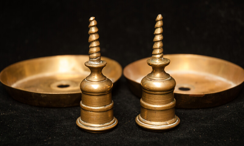 A pair of early seventeenth century brass church bench candle sticks.