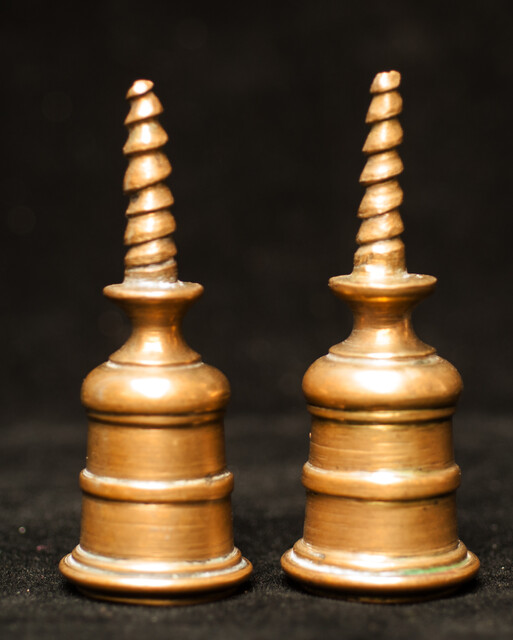 A pair of early seventeenth century brass church bench candle sticks.