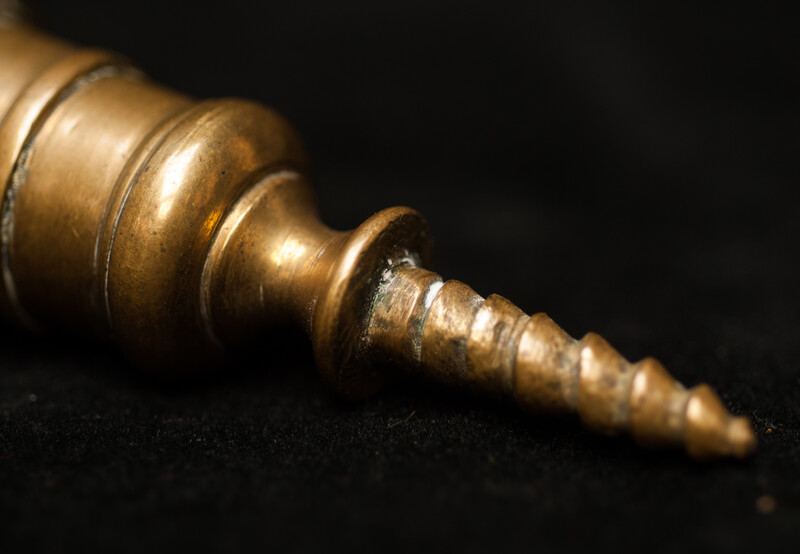 A pair of early seventeenth century brass church bench candle sticks.