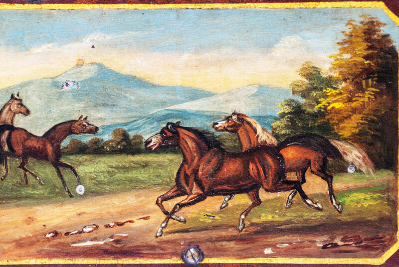 A paper mache tobacco box with a beautifully painted landscape with horses.