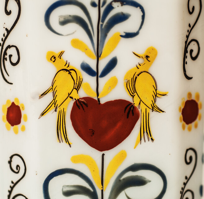 A rare eightteenth century opaline Bohemian bottle with cold enamel painting of flowers and a heart with two doves. With original pewter screw on top.