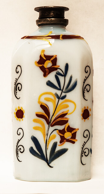 A rare eightteenth century opaline Bohemian bottle with cold enamel painting of flowers and a heart with two doves. With original pewter screw on top.