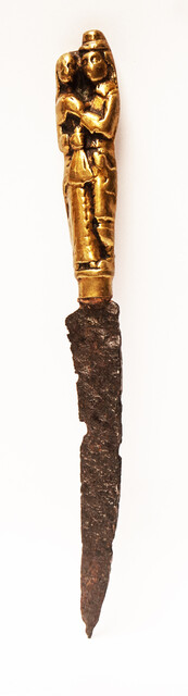 A seventeenth century knife with a brass handle showing a lady and a gentleman.