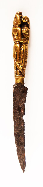 A seventeenth century knife with a brass handle showing a lady and a gentleman.