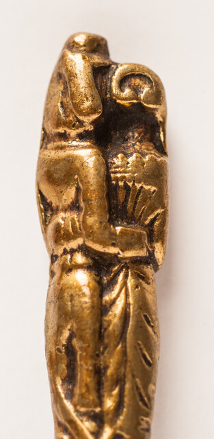 A seventeenth century knife with a brass handle showing a lady and a gentleman.