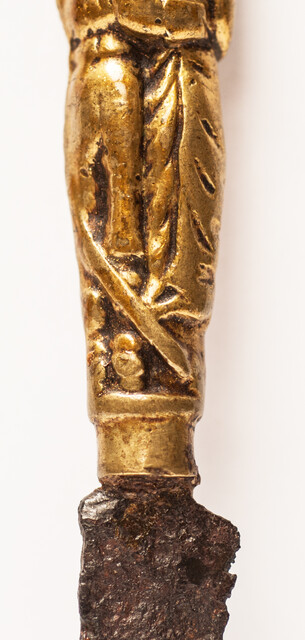 A seventeenth century knife with a brass handle showing a lady and a gentleman.