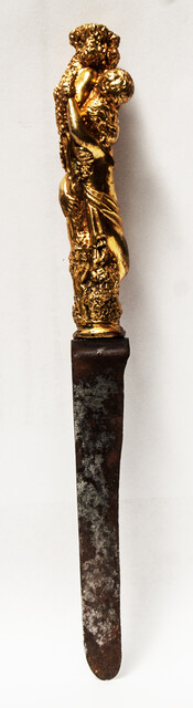 A seventeenth century knife with a brass handle showing two embracing angels.