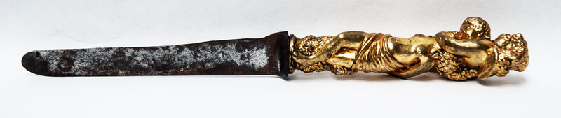 A seventeenth century knife with a brass handle showing two embracing angels.