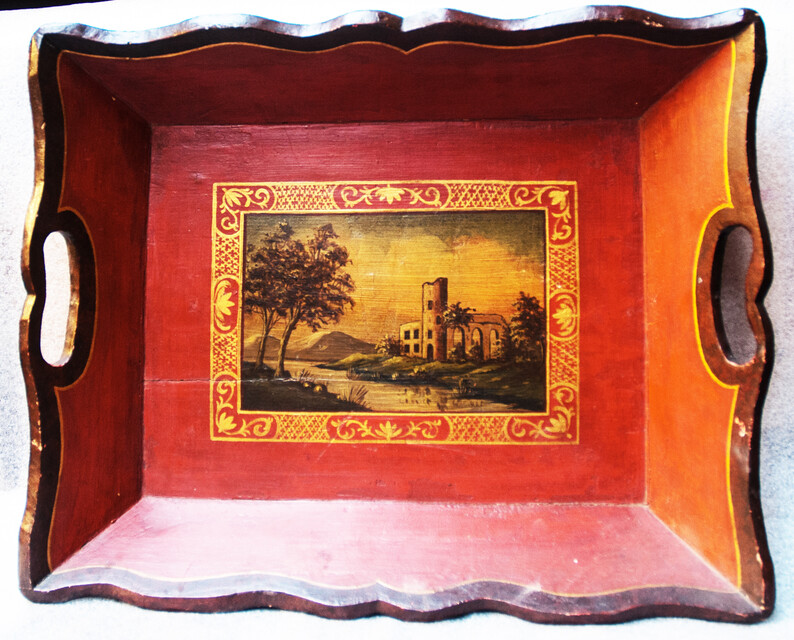 A small nineteenth century serving tray with a handpainted Italianate landscape.