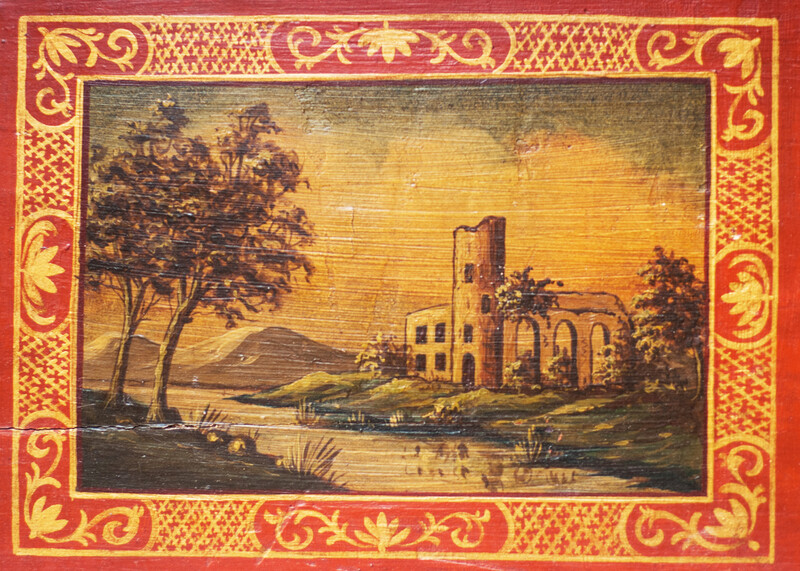 A small nineteenth century serving tray with a handpainted Italianate landscape.