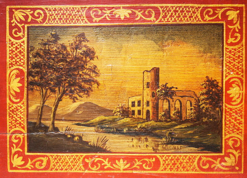 A small nineteenth century serving tray with a handpainted Italianate landscape.