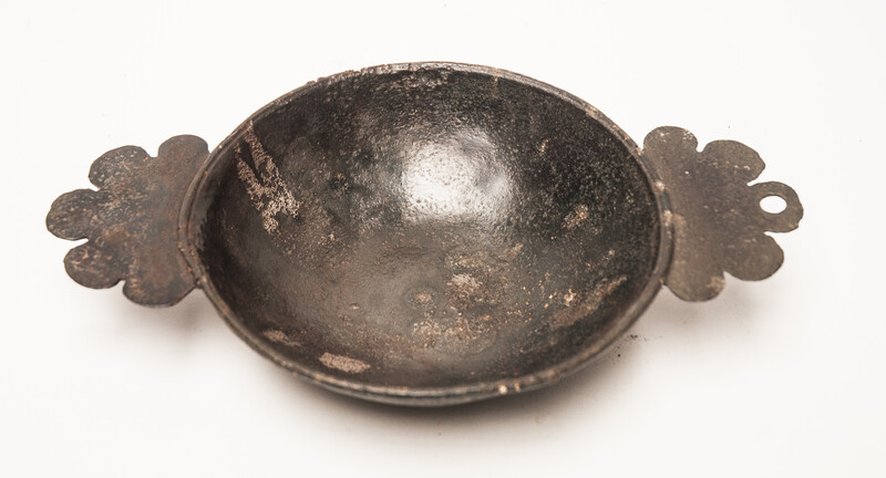 An early seventeenth century pewter porridge bowl with a rose hallmark.