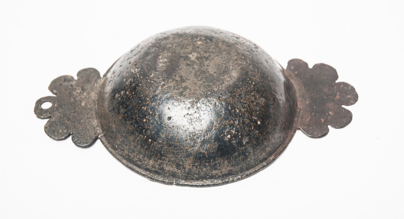 An early seventeenth century pewter porridge bowl with a rose hallmark.