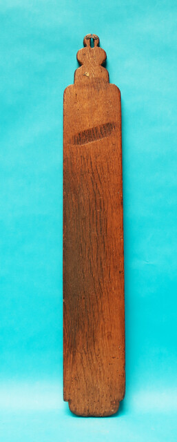 An oak Frisian mangleboard with kerbschnitt and dated 1665. With rosewood manglestick.